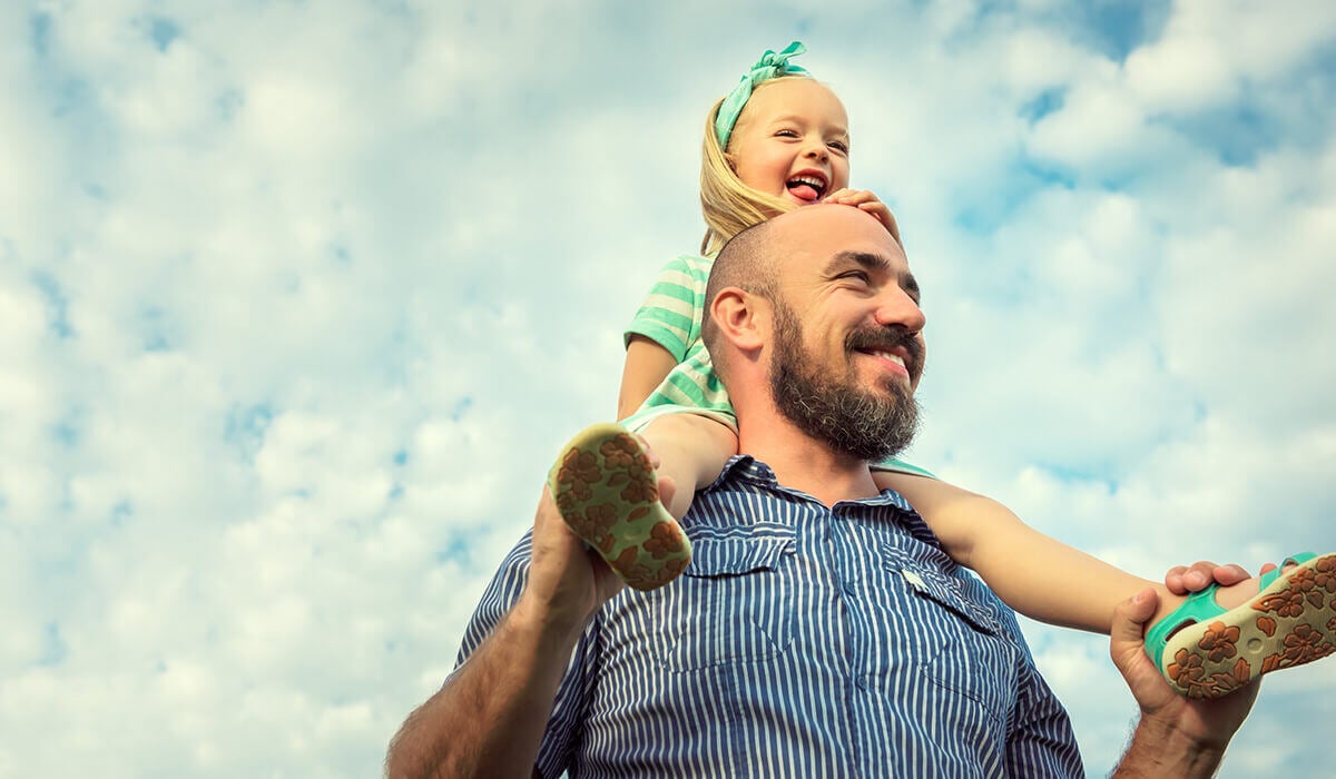 A man carrying a child on his shoulders