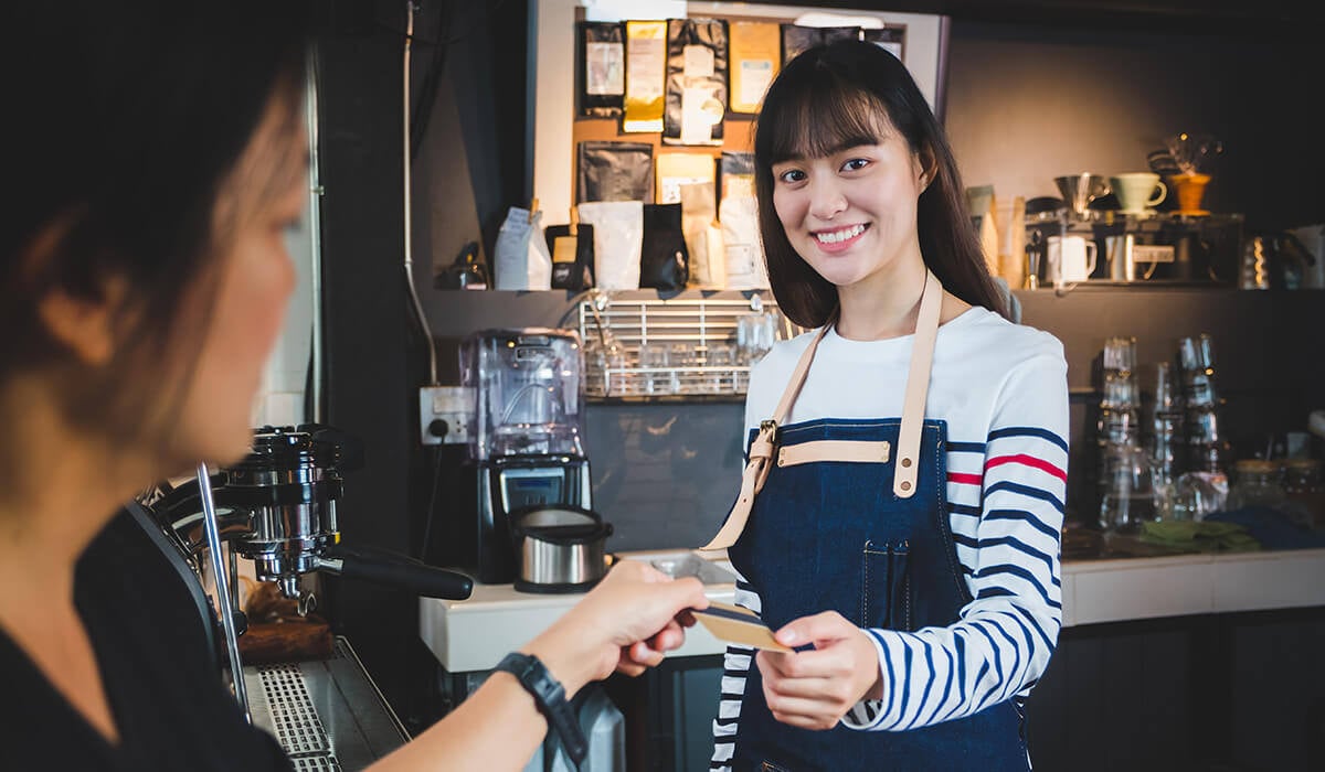 A server in a coffee shop serving a customer